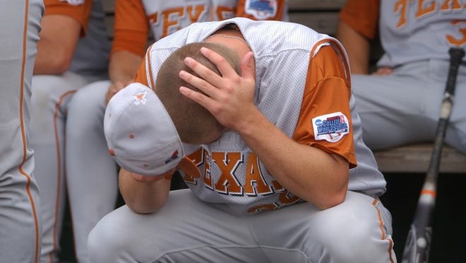 6/27/04 - Jay Janner/American-Statesman - Texas Pitcher Kyle Yates hangs his head in the dugout after Texas lost 3-2 to Cal State Fullerton at the College World Series at Rosenblatt Stadium in Omaha, Nebraska, on Sunday June 27, 2004.