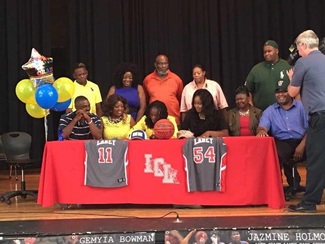 Laney basketball stars Gemiya Bowman (center, left) and Jazmine Holmon signed with colleges during a ceremony at the school Wednesday. Bowman will play at Albany State and Bowman will join Mississippi Valley State.