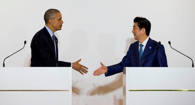 President Barack Obama and Japanese Prime Minister Shinzo Abe shake hands after speaking to media on Wednesday in Shima, Japan.