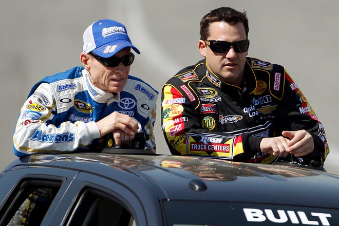 Tony Stewart, right, and Mark Martin take part in the drivers' introductory lap before the NASCAR Sprint Cup Series auto race in Fontana, Calif., Sunday, March 24, 2013. (AP Photo/Reed Saxon)