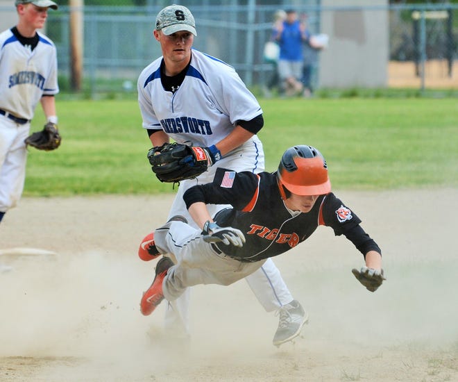 Somersworth's Chris April, back, tags out Farmington's Jake Squires to end a rundown between second and third during D-III baseball action Wednesday in Farmington. Mike Whaley/Fosters.com
