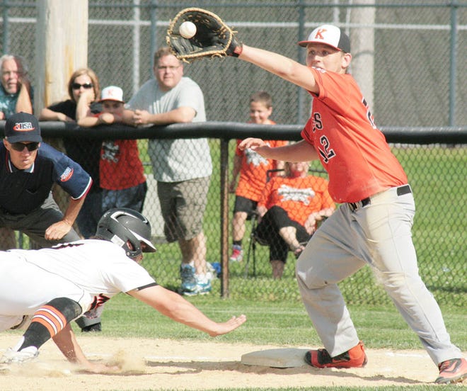 Kewanee first baseman Logan Bennison stretches for a pickoff throw as a Macomb base runner dives safely back to the bag.