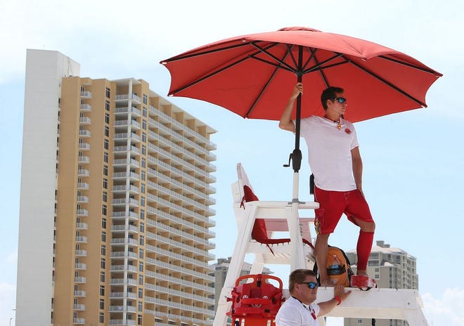 Lifeguards Bryant Clayton, top, and Drew Bronnenberg watch beachgoers at the M.B. Miller County Pier in Panama City Beach on Wednesday.
