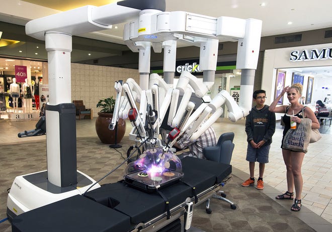 CHIEFTAIN PHOTO/JOHN JAQUES Christine Newell (right) and Shawn Cordova, 13, react after operating the da Vinci machine during a Parkview Medical Center presentation Wednesday at the Pueblo Mall.