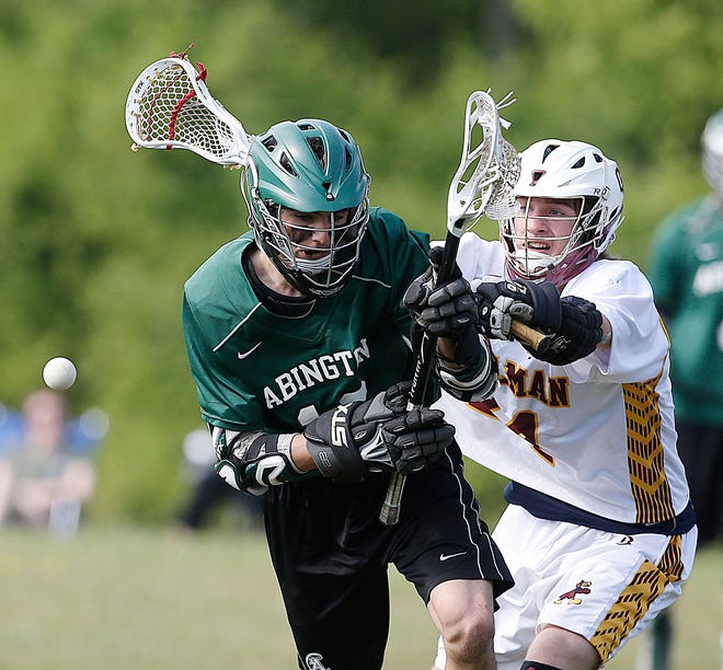 Cardinal Spellman's Tom Crane knocks the ball loose form Abington's Brian Cashman during a boys lacrosse game Wednesday, May 25, 2016.