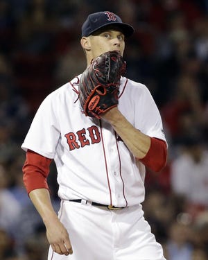 Red Sox starting pitcher Clay Buchholz reacts after giving up a two-run home run to the Rockies' Dustin Garneau during the fifth inning of Boston's 8-2 loss on Thursday night. Buchholz allowed three home runs and fell to 2-5 on the season.