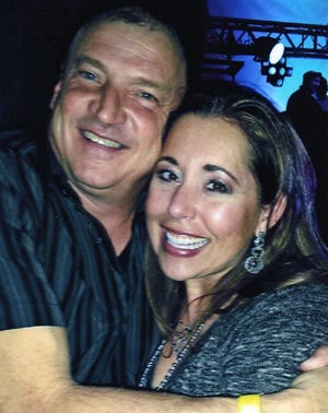 This profile photo from Mark Penland's Facebook page shows him and his wife, Michelle Dinkins-Penland.