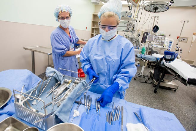 Registered Nurse Pam Poliska (left) helps Certified Surgical Technologist Sara Maurici count surgical instruments June 2, 2014, in an operating room at SwedishAmerican Hospital in Rockford. RRSTAR.COM FILE PHOTO