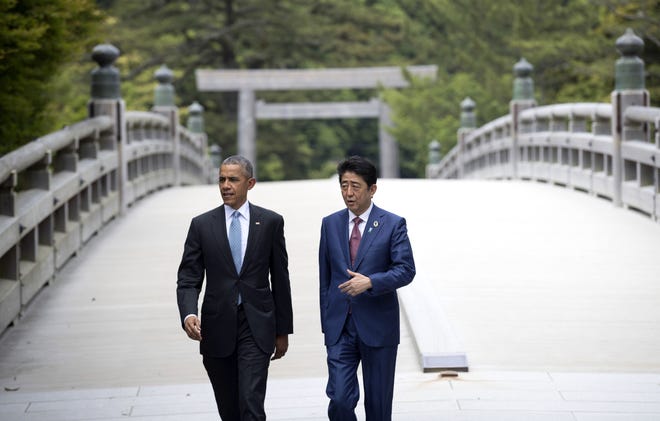 U.S. President Barack Obama, left, and Japan Prime Minister Shinzo Abe walk across the bridge as they visit the Ise Jingu shrine in Ise, Japan, Thursday, May 26, 2016. Obama is in Japan for the G-7 summit and plans to visit Hiroshima on Friday. (Doug Mills/Pool Photo via AP)