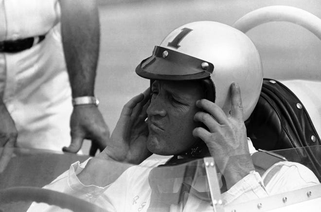 In this May 16, 1964, file photo, A.J. Foyt removes his helmet after qualifying for a second-row starting spot for the Indianapolis 500 auto race in Indianapolis, Ind. THE ASSOCIATED PRESS