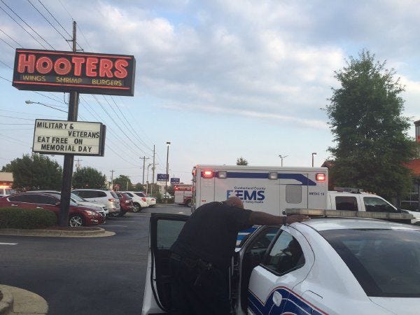 Police say two men were assaulted by six others inside Hooters on the 500 block of North McPherson Church Road.