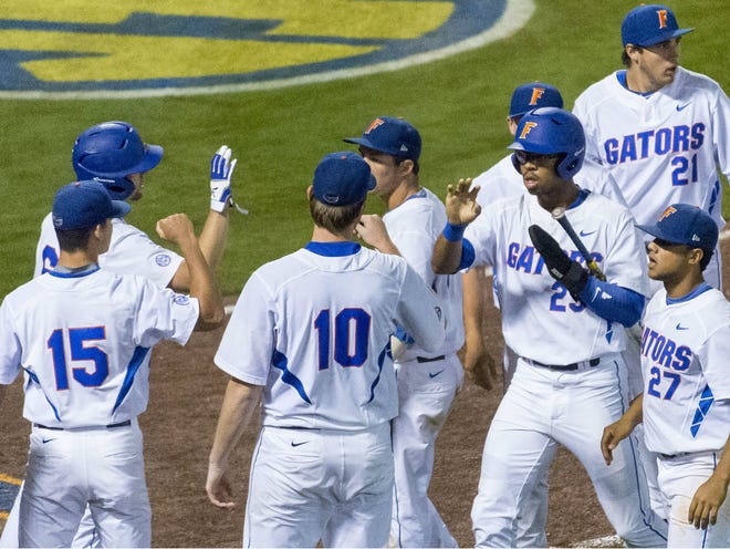Florida celebrates scoring the game-tying run against LSU Wednesday. The Gators beat Alabama 5-4 Thursday to stay alive in the SEC tournament.