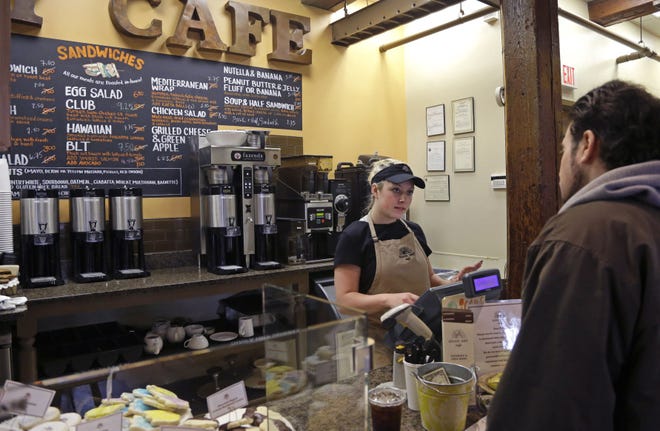 In this Wednesday, March 23, 2016, photo, Kayla Mitchell serves a customer at Good Day Cafe in North Andover, Mass. On Friday, May 27, 2016, the Commerce Department issues the second of three estimates of how the U.S. economy performed in the January-March quarter. (AP Photo/Elise Amendola)