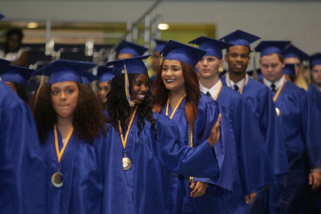 It's a big night, sure, but there's always time to sneak a smile and wave to family and friends at Mainland High School's graduation ceremony for the Class of 2016 at the Ocean Center in Daytona Beach on Friday.
News-Journal/LOLA GOMEZ