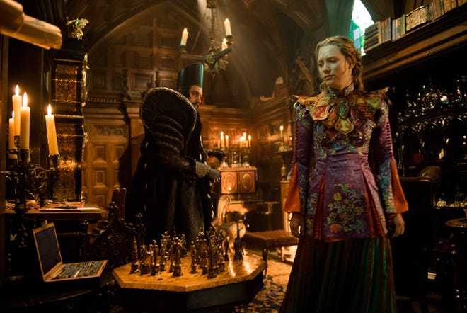 In this image released by Disney, Sacha Baron Cohen, left, and Mia Wasikowska appear in a scene from "Alice Through The Looking Glass." (Peter Mountain/Disney via AP)