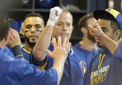 Milwaukee Brewers' Aaron Hill is congratulated after hitting a home run during the fifth inning of a baseball game against the Cincinnati Reds Friday, May 27, 2016, in Milwaukee. (AP Photo/Morry Gash)