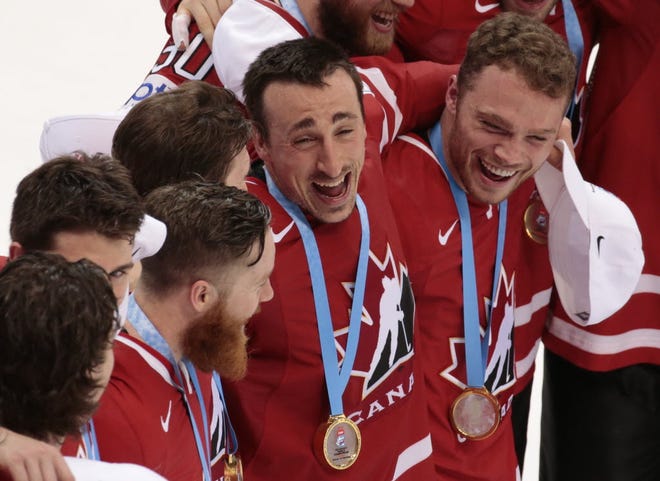 Brad Marchand sings 'O Canada' with his teammates after winning the gold medal on Sunday in Russia.