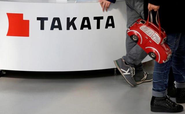 Visitors walk past a logo of Takata Corp on its display at a showroom for vehicles in Tokyo, Japan February 5, 2016. REUTERS/Toru Hanai/File Photo