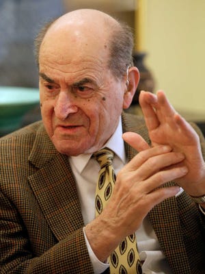 FILE - In this Feb. 5, 2014 file photo, Dr. Henry Heimlich describes the maneuver he developed to help clear obstructions from the windpipes of choking victims, while being interviewed at his home in Cincinnati. Heimlich recently used the emergency technique for the first time himself to save a woman choking on food at his senior living center. Heimlich said Thursday, May 26, 2016 that he has demonstrated the well-known maneuver many times through the years but had never before used it on a person who was choking. (AP Photo/Al Behrman)