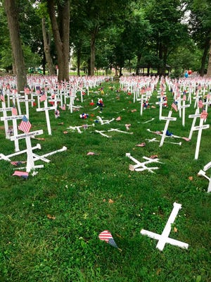This photo provided by the Henderson Police Department shows a Memorial Day display of crosses after a vehicle drove through them in Henderson, Ky.'s Central Park on Saturday, May 28, 2016. The display honors the names of more than 5,000 from the city and county of Henderson who served in conflicts dating back to the Revolutionary War. (Joe Whitledge/Henderson Police Department via AP)