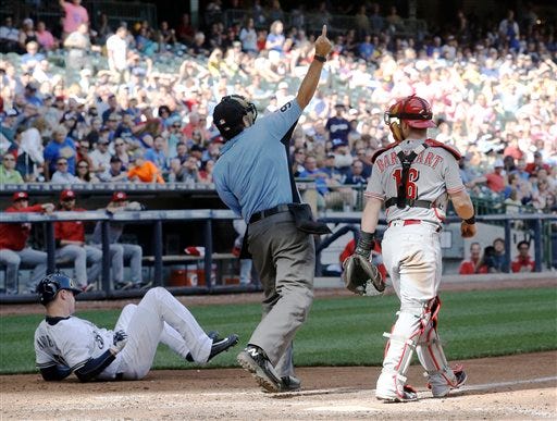 Home plate umpire James Hoye ejects Cincinnati Reds starting pitcher Alfredo Simon after hitting Milwaukee Brewers' Chase Anderson with a pitch during the fifth inning of a baseball game Saturday, May 28, 2016, in Milwaukee. (AP Photo/Morry Gash)