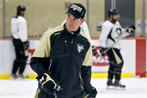 Pittsburgh Penguins head coach Mike Sullivan skates with the team during NHL hockey practice at the UPMC Lemieux Sports Complex, Saturday, May 28, 2016, in Cranberry, Pa. The Penguins host the San Jose Sharks in Game 1 of the Stanley Cup Finals on Monday, May 30. Mike Sullivan wasn't Rutherford's first choice to be the Pittsburgh Penguins coach. However, the duo have worked in lock step with Rutherford acquiring quick, skilled players to go with Sullivan's aggressive, pressure-heavy style which lead the franchise to a Stanley Cup appearance that appeared far-fetched when Sullivan was hired in December. (AP Photo/Keith Srakocic)