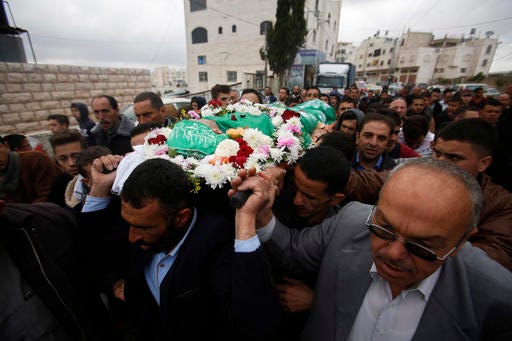 Palestinians chant slogans as they carry the body of Abdel-Fattah al-Sharif, during his funeral, in the West Bank city of Hebron, Saturday, May 28, 2016. Al-Sharif was killed by an Israeli soldier in March while lying on the ground seriously wounded after he and another Palestinian attacked IDF troops.(AP Photo/Nasser Shiyoukhi)