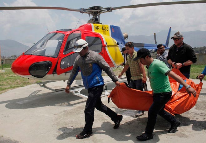 In this May 26, 2016, file photo, the body of a climber who died during a Mount Everest expedition, is carried to Teaching hospital in Kathmandu, Nepal. (AP Photo/Niranjan Shrestha, File)