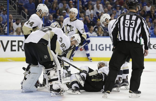 Teammates check on Penguins defenseman Trevor Daley after he was hurt against the Lightning during the second period of Game 4 of the NHL hockey Stanley Cup Eastern Conference final Friday in Tampa, Fla.