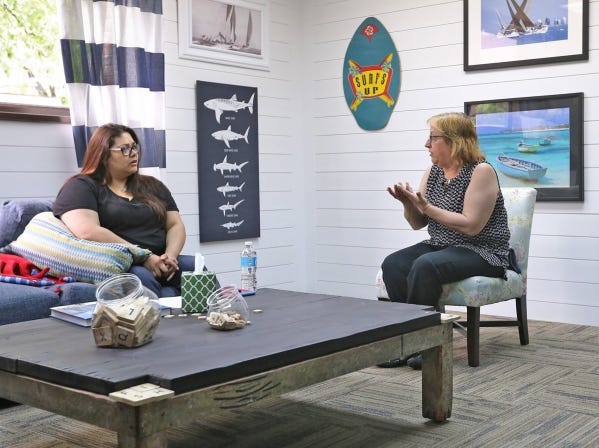 Annette Arriaga, left, listens to Lesley Puett, assistant director of the Hannah Neil Center, during a recent counseling session at the center's South Side facility.