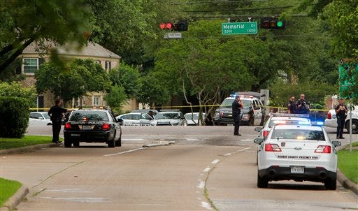 Police block the intersection at Memorial and Wilcrest as they respond to a shooting where authorities say a gunman and at least one other person are dead, Sunday, May 29, 2016, in Houston. (Gary Fountain/Houston Chronicle via AP) MANDATORY CREDIT