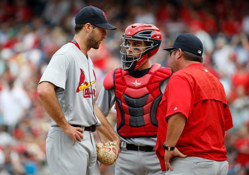 St. Louis Cardinals starting pitcher Michael Wacha, left, catcher Eric Fryer, center, and pitching coach Derek Lilliquist talk on the mound during the fourth inning of a baseball game against the Washington Nationals at Nationals Park, Sunday, May 29, 2016, in Washington. (AP Photo/Alex Brandon)