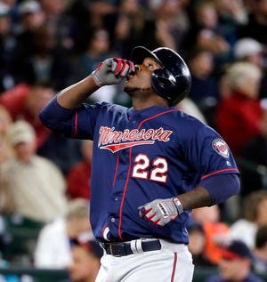 Minnesota Twins' Miguel Sano gestures before pointing skyward as he crosses home on his home run against the Seattle Mariners in the fourth inning of a baseball game Sunday, May 29, 2016, in Seattle. (AP Photo/Elaine Thompson)