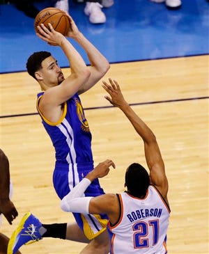 Golden State Warriors guard Klay Thompson (11) shoots over Oklahoma City Thunder guard Andre Roberson (21) during the first half in Game 6 of the NBA basketball Western Conference Finals in Oklahoma City, Saturday, May 28, 2016. (AP Photo/Alonzo Adams)