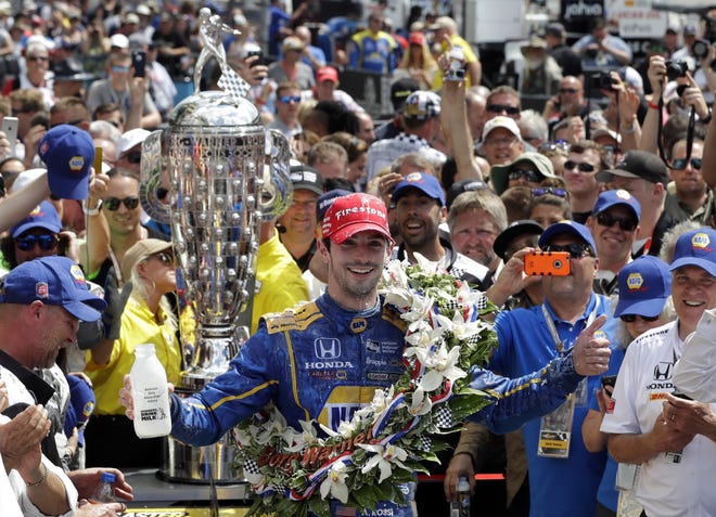 Alexander Rossi celebrates after winning the 100th running of the Indianapolis 500 auto race at Indianapolis Motor Speedway in Indianapolis on Sunday. Rossi had just enough fuel to cross the line for the victory. (AP Photo/Darron Cummings)