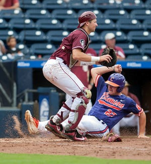 Clemson's Chris Williams slides into home past Florida State catcher Cal Raleigh during the second inning of the ACC Championship game on Sunday at the Durham Bulls Athletic Park in Durham, N.C. Clemson defeated Florida State 18-13. (Kaitlin McKeown/The Herald-Sun via AP)