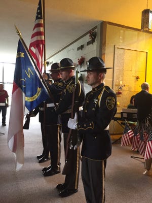 The Cleveland County Sheriff's Office Honor Guard conducted the posting of colors at a Memorial Day program on Sunday. Casey White/The Star