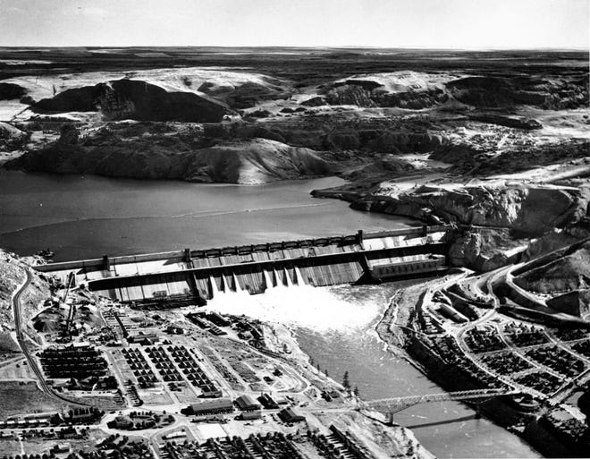 The Grand Coulee Dam on the Columbia River near Spokane, Wash., nears completion on Oct. 2, 1941. It was 75 years ago that folk singer Woody Guthrie traveled across Washington and Oregon, composing 26 songs that extolled the virtues of Grand Coulee Dam and the electricity it produced. (AP Photo, file)