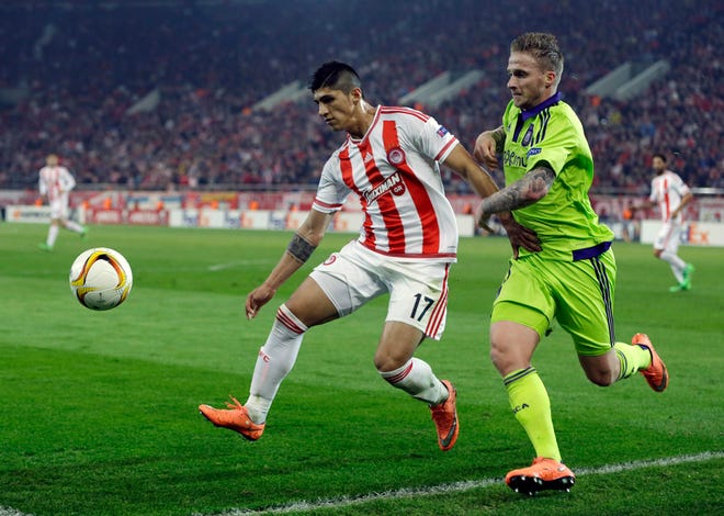 FILE - In this Thursday, Feb. 25, 2016 file photo, Olympiakos' Alan Pulido, left, fights for the ball with Anderlecht's Alexander Buttner during the Europa League round of 32 soccer match at the Georgios Karaiskakis stadium in the port of Piraeus, near Athens. A state official says that Mexican soccer star Alan Pulido has been kidnapped in the northern border state of Tamaulipas. Pulido is a forward for the Greek team Olympiacos and has made several appearances for Mexico's national team, though he wasn't called up for the upcoming Copa America tournament. The official says the 25-year-old player was kidnapped near his hometown of Ciudad Victoria on Sunday, May 29, 2016 after leaving a party. (AP Photo/Thanassis Stavrakis, file)