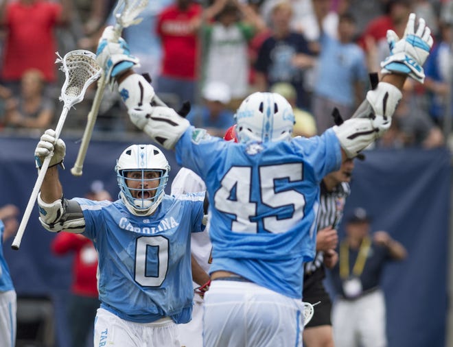 North Carolina attackman Steve Pontrello, left, races toward teammate Chris Cloutier after Cloutier scored the game-winning goal to win the men's NCAA college lacrosse championship in Philadelphia. Clem Murray/The Philadelphia Inquirer via AP