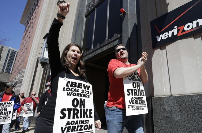 Verizon workers are shown picketing outside one of the company's facilities in Boston on April 13. About 39,000 Verizon Communications Inc. landline and cable employees in nine eastern states and Washington, D.C., have been on strike since April. They had been working without a contract since last August. AP Photo/Steven Senne