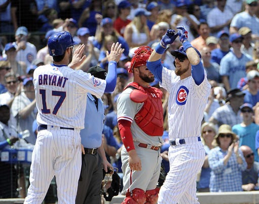 Chicago Cubs' Ben Zobrist, right, is greeted by Kris Bryant (17) after hitting a three-run home run against the Philadelphia Phillies during the third inning of a baseball game, Sunday, May 29, 2016, in Chicago. (AP Photo/David Banks)