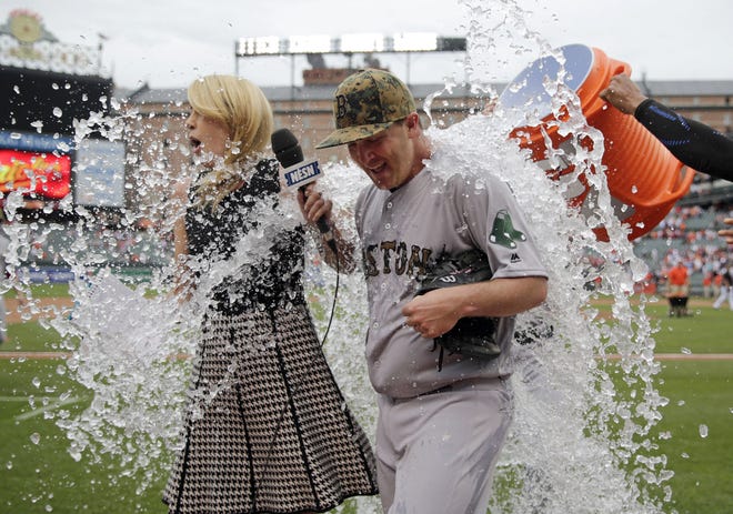 Red Sox starting pitcher Steven Wright, right, is doused by teammates during a post-game television interview after closing out Monday's win. AP Photo
