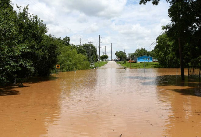 Sixth Street is impassible due to rising flood waters from the Brazos River Sunday, May 29, 2016, in Rosenberg, Texas.