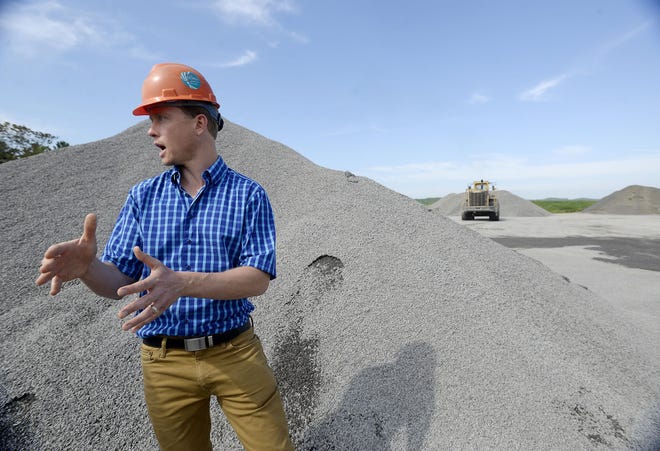 Amerikohl Aggregates Vice President Jamie Stilley stands near a pile of crushed limestone at the McMillin site on Friday in Wayne Township. Another surface mining operation is under way near Ellport in Wayne Township.