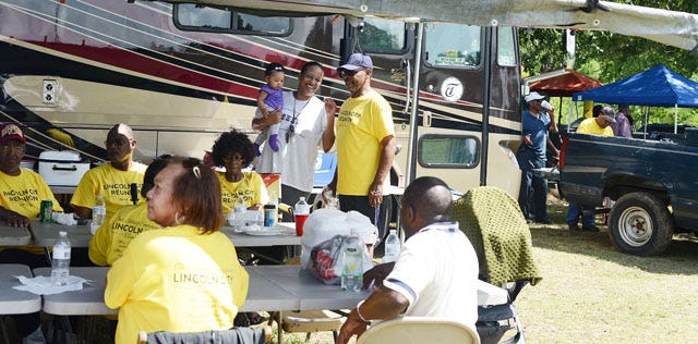 Yellow Lincoln City reunion shirts are worn as family and friends gather on Sunday for the annual reunion at Holloway Center.
