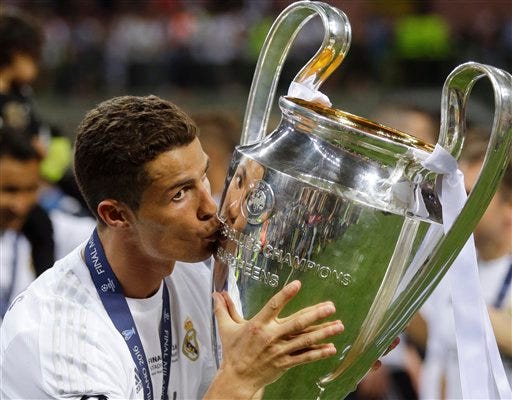 Real Madrid's Cristiano Ronaldo kisses the trophy after the Champions League final soccer match between Real Madrid and Atletico Madrid at the San Siro stadium in Milan, Italy, Saturday, May 28, 2016. Real Madrid won 5-4 on penalties after the match ended 1-1 after extra time. (AP Photo/Andrew Medichini)