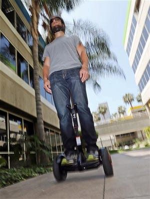In this May 27, 2016, photo, company representative Zach Servideo demonstrates Segway's new self-balancing scooter, the MiniPro, in downtown Los Angeles. The MiniPro is going on sale on Amazon, Wednesday, June 1, 2016. Hoverboards are attempting a comeback in the U.S., months after videos showing them bursting into flame went viral. (AP Photo/Reed Saxon)