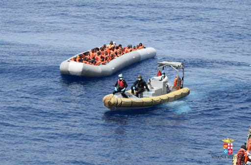This undated image made available Monday, May 30, 2016 by the Italian Navy Marina Militare shows migrants being rescued at sea. Survivor accounts have pushed to more than 700 the number of migrants feared dead in Mediterranean Sea shipwrecks over three days in the past week, even as rescue ships saved thousands of others in daring operations. (Italian Navy via AP)