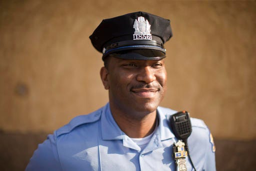 Philadelphia police Officer Eric Tyler poses for a photograph, Thursday, May 26, 2016, in Philadelphia. Tyler was recognized for using a stun gun instead of a real gun on a suspect who threatened to shoot his colleague in February. Tyler, who has never shot anyone in his 12-year career, said he considered using deadly force but made a split-second decision not to. More than 40 Philadelphia officers have received awards since December for defusing conflicts without shooting, clubbing or otherwise using maximum force against anyone. The awards reflect an increasing emphasis on “de-escalation” in police work. (AP Photo/Matt Rourke)